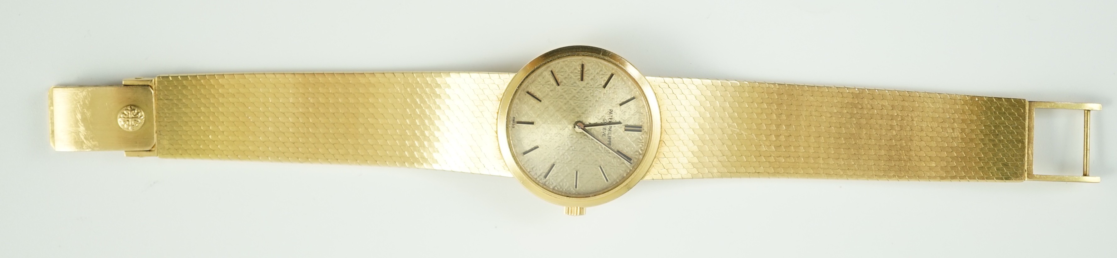 A lady's 18ct gold Patek Philippe manual wind wrist watch, on an integral 18ct gold Patek Philippe bracelet